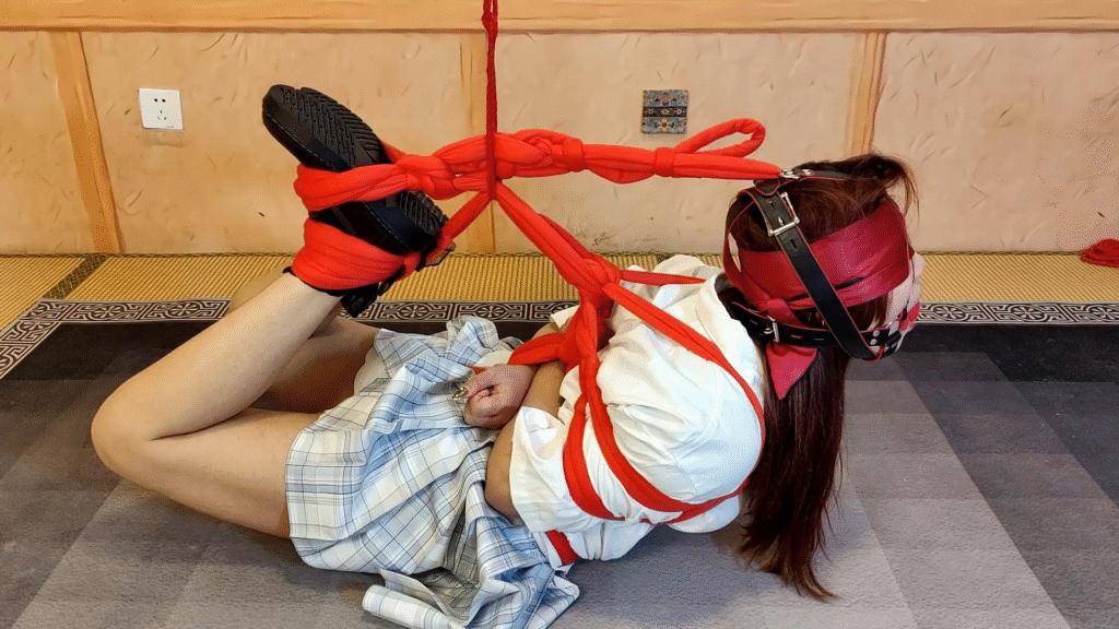 red rope arched back hogtie blindfold and ballgagged